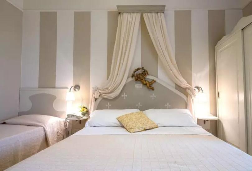 Camera accogliente con letto matrimoniale, decorazioni eleganti e illuminazione soffusa.